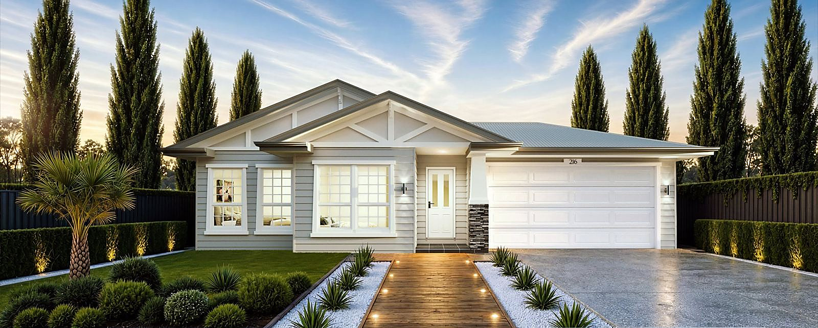 Hamptons-style home with lit pathway